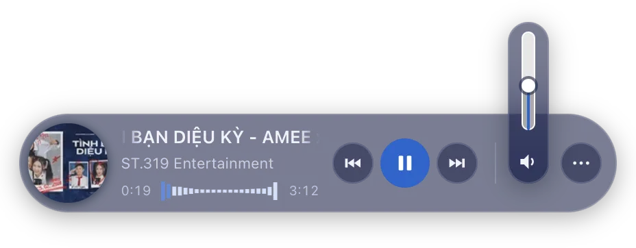 The mini player with the volume flyout expanded upward, showing a vertical slider above the pill.